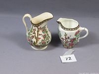Two Coalport Indian Tree pattern creamers with floral and bird designs. Noted some discoloration on the surface.