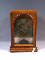 Front view of Junghans Westminster wooden clock with glass door and clock face visible.