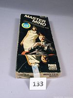 Front view of the Master Mind game box showing the vintage packaging with man and woman on cover and the 1973 British Game of the Year emblem.