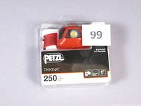 Photo of the Petzl Tikkina headlamp in original retail packaging showing the headlamp and branding.