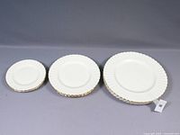 Full set of 12 plates arranged by size: bread, luncheon, and dinner plates.