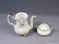 Coffee pot and sugar bowl set with gold rim detail and white bone china body, coffee pot missing lid