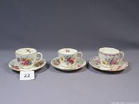 Three Royal Crown Derby Posies cups and matching saucers side by side