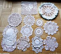 Group photo of all 15 white crochet lace doilies showing size and detail variety, square doily sized about 7.5 inches