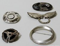 All five brooches and scarf clip together showing shape and design variety