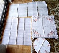Four table mats laid out on floor showing sizes, patterns, and shapes.