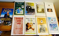 Nine assorted booklets laid out on a table including seven issues of What's New in Dowsing, Solace and Joy, and Going Organic.