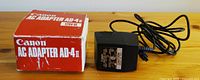 Canon AC Adapter AD-4 II with original box showing model and voltage details.