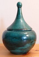 Closed ceramic dish with tall conical lid and rounded knob