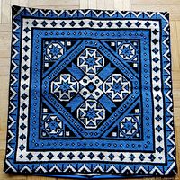 Full view of the square handmade needlepoint cushion cover with blue and black geometric star and diamond pattern