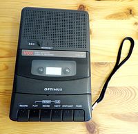 Front view showing VOX voice activated cassette recorder with buttons and cassette window.