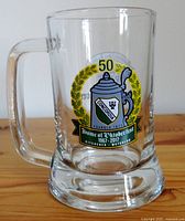 Kitchener-Waterloo Oktoberfest 50th Anniversary beer stein, showing the colorful commemorative logo with 50 years and Concordia emblem.