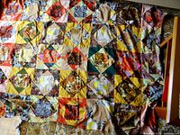 Full view of the unfinished machine-pieced quilt showing all fabric squares and overall size