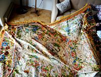 View of full bedspread spread on floor showing overall pattern and size