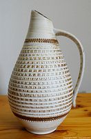 Front and angle view of the vintage Dumler & Breiden pottery vase/pitcher showing textured horizontal ridges and the attached handle.