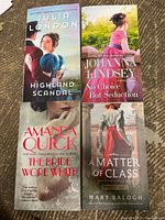 Front covers of the four paperback fiction books laid out on the floor, showing title and author: Julia London - Highland Scandal, Johanna Lindsey - No Choice But Seduction, Amanda Quick - The Bride Wore White, Mary Balogh - A Matter of Class.