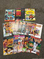 Photo showing entire collection of Nintendo Power magazines and game guides laid out on floor.