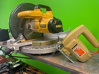 Both DeWalt miter saw and Black & Decker jigsaw side by side to show size and condition