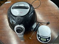 Top view of Simple Chef air fryer showing controls and Ozeri digital kitchen scale on table