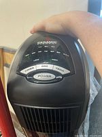 Close-up of the control panel of the Lasko ceramic tower heater showing buttons and temperature settings.