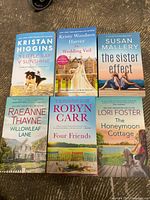 Top-down view of six romance paperback books arranged side by side showing front covers.