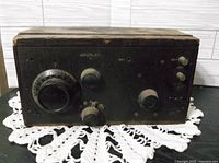 Front view of antique Crosley Model 51 radio receiver showing large tuning dial, smaller knobs, and worn black finish.