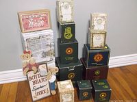 Full lot view showing stacked original boxes with Boyds Bears logos and several wooden decorative signs with bear characters.