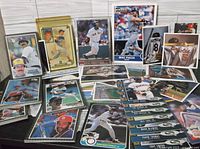 Photo showing multiple large baseball cards spread out, several players and styles included