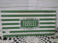 Box showing green and white striped design with 'Handipt Candles' label and 'fashioned by Colonial Candle of Cape Cod' text.