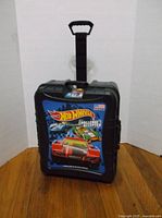 Front view of the Hot Wheels Challenge Case showing colorful graphic and handle.