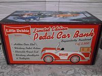 Box showing Little Debbie branding and details about the pedal car bank including limited edition and sequential numbering.
