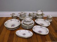 Full set arrangement showing variety of cups, plates, and serving dishes.