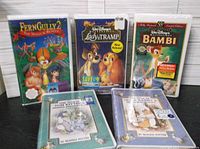 Front view of three Disney VHS tapes: FernGully 2, Lady and the Tramp, and Bambi, sealed in original plastic.