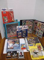 Overall view of sports figures, cards in binders, and magazines on a floor surface.