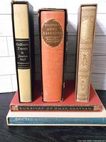 Front view of five vintage books in slipcovers with titles: Gulliver's Travels, Anna Karenina, The Mystery of Edwin Drood, Rubaiyat of Omar Khayyam, Doctor Dolittle.