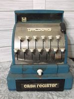 Front view of the toy cash register showing 10 buttons labeled with no sale sign and Tom Thumb logo.