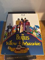 Front cover of The Beatles Yellow Submarine Collector's Edition DVD showing animated artwork with the Beatles characters and the yellow submarine in colorful cartoon style.