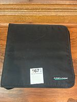 Closed black Case Logic CD holder with sticker labeled '167' on cover.