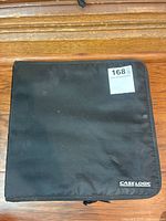 Black Case Logic CD holder closed, made of nylon fabric with zip closure.