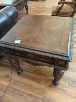 Top view showing wood grain pattern and surface scratches on the square table top.