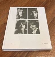 Front cover of the hardcover book showing black and white portrait photos of the four Beatles members and edition number 0043578.