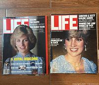Two LIFE magazines side by side on a wooden floor, featuring Princess Diana on both covers. December 1982 on right and November 1985 on left.