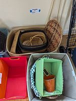 Top view arrangement of various wicker and fabric organizer baskets stacked inside larger baskets, showing different sizes and colors including orange, green, and natural wicker.