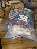Packed clear bag with various cotton and mixed fabric quilt pieces labeled 'Quilting Fabric'.