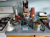 Full view of the vintage kitchen tool lot on the counter showing all items included in the lot.