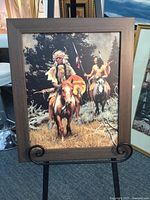 Frontal view of the wood framed canvas print showing two Native American braves on horseback outdoors.