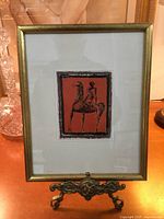 Framed print on decorative stand showing full frame and artwork