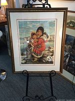 Full view of the framed print on an easel, showing the entire artwork and its frame.