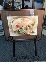 Front view of the framed watercolor painting of a gardening scene by Peggy Jehn with copper-colored frame and mat.