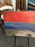 Full view of the abstract oil painting on canvas showing bands of red, blue and gray with textured brushstrokes.